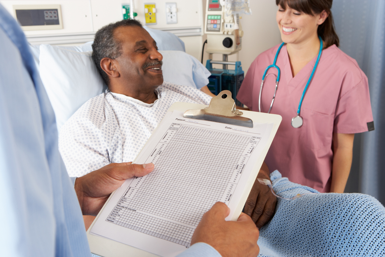 Permanent Healthcare Professional Looking At Chart With Senior Male Patient