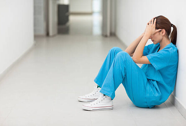 nurse sitting sad depressed covid suicidal