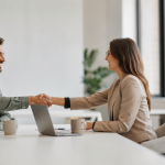Independent recruiter and staffing firm partner shaking hands over a split fee recruiting agreement